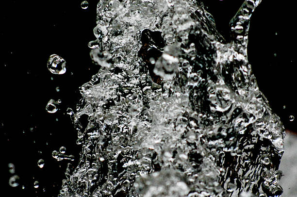 istock Water drops levitating in the air in dark. Splashing 603291468
