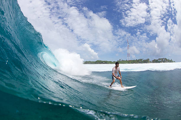 istock Surfer on a beatuiful blue wave in the tropics 603291616