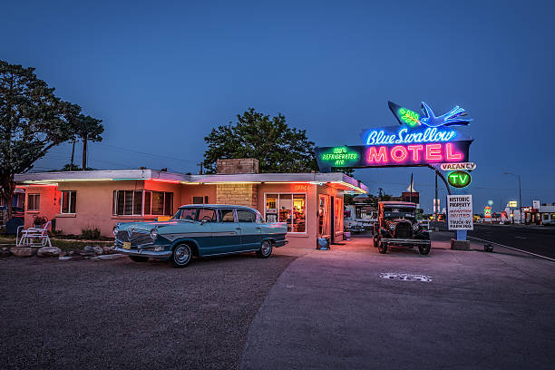Historic Blue Swallow Motel in Tucumcari, New Mexico Tucumcari, New Mexico, USA - May 13, 2016 : Historic Blue Swallow Motel with vintage cars parked in front of it. This building is listed on the National Register of Historic Places in New Mexico as a part of historic U.S. Route 66. route 66 sign old road stock pictures, royalty-free photos & images