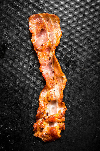istock Strip of fried bacon in pan. 603296964