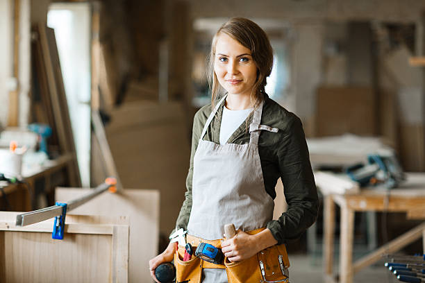 Diy woman Pretty carpenter in uniform looking at camera craftsperson stock pictures, royalty-free photos & images
