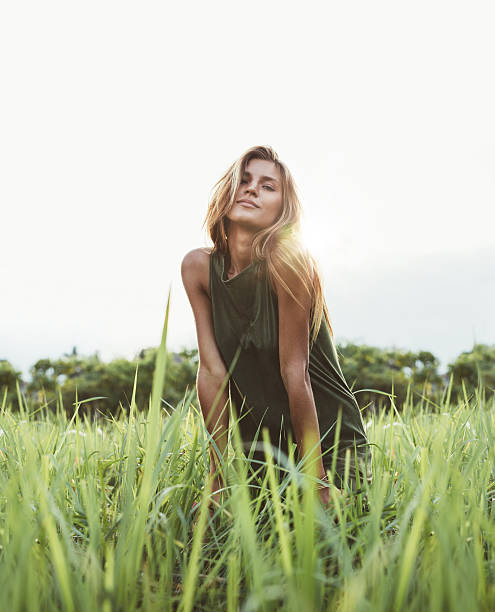 istock Attractive young lady sitting in the field 603313368