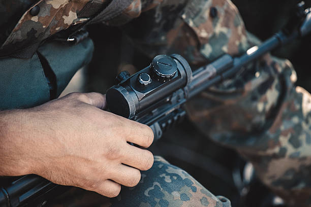 istock Soldier adjusts optical sight on a rifle. 603315182
