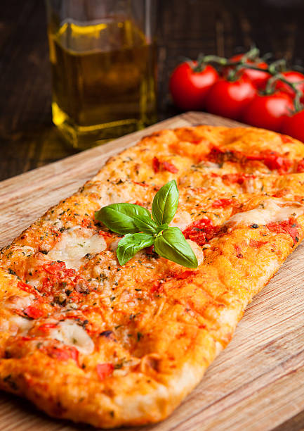 istock Pizza bread with tomatoes and olive oil on wooden board 603315456
