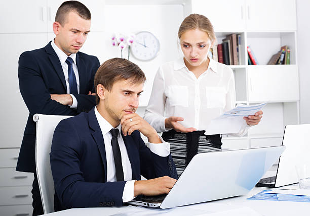 istock three worried coworkers in firm office 603317324