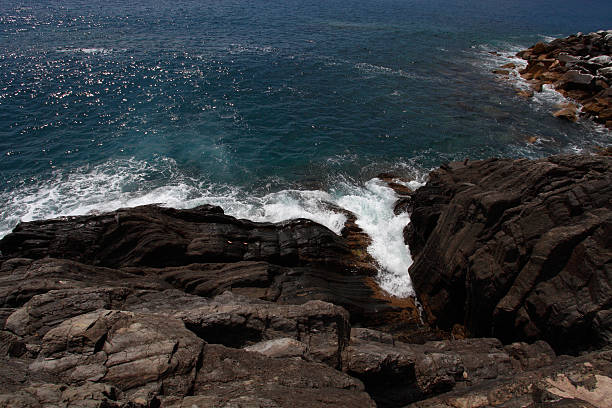 istock waves crashing on the rocks i 603318388