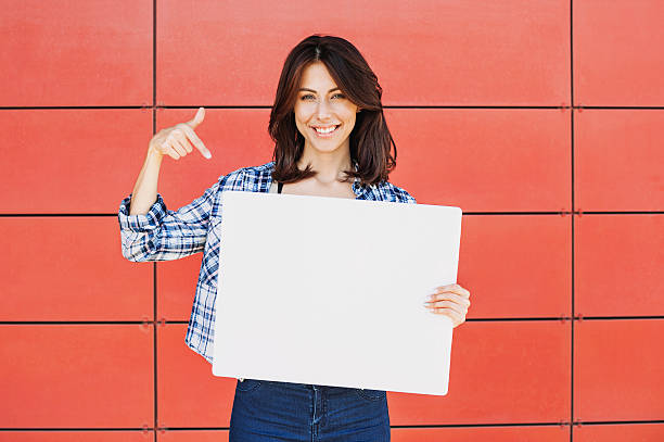 Happy woman showing white banner