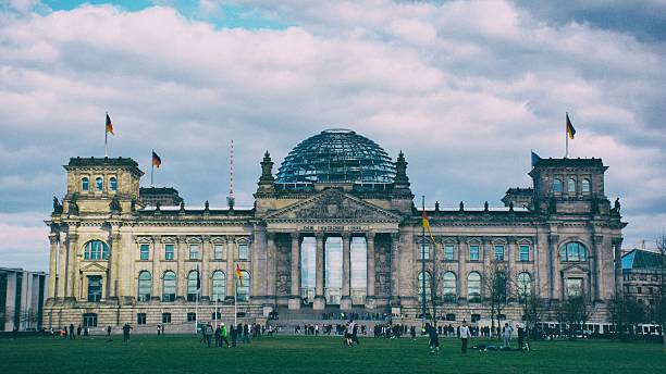 istock People At The Reichstag Against Cloudy Sky 603765999