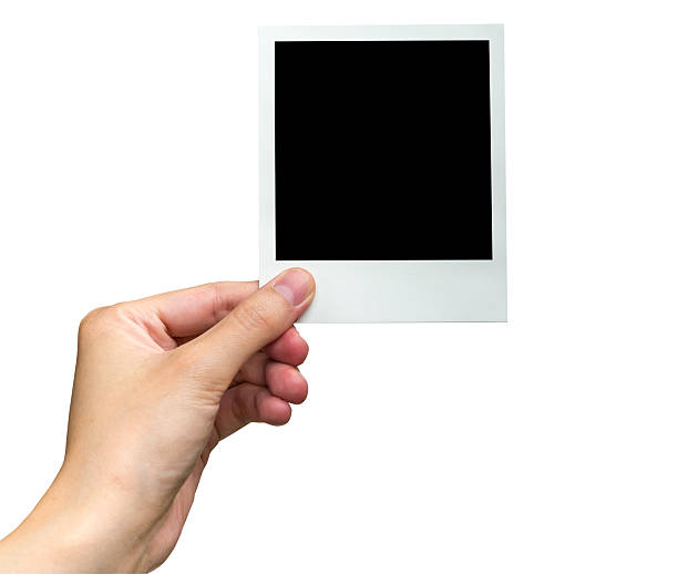 istock hand holding photo frame on isolated white 603823846