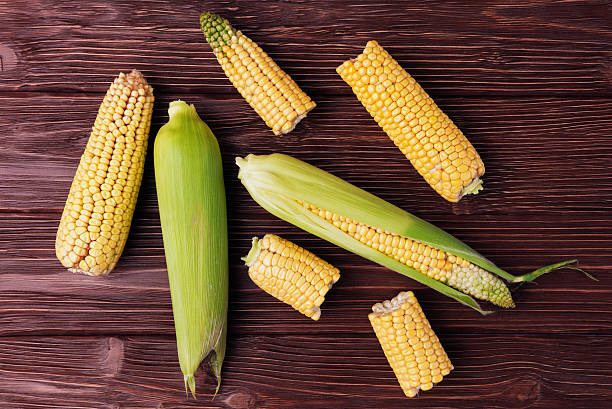 istock Top view of ripe corn on old wooden background 603827570