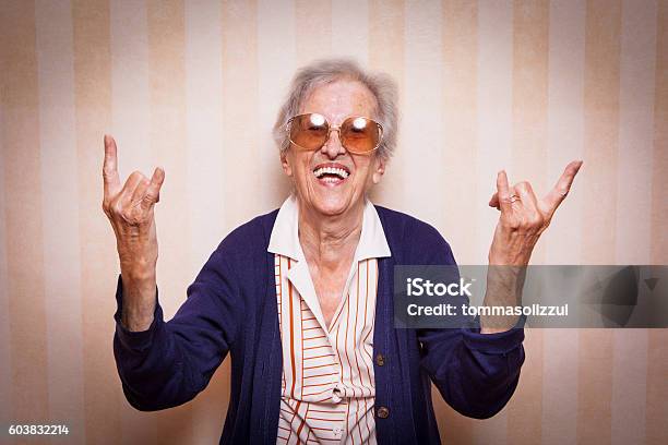 Cool Elder Lady Making Rock On Sign Stock Photo - Download Image Now - Cool Attitude, One Woman Only, Rock Music