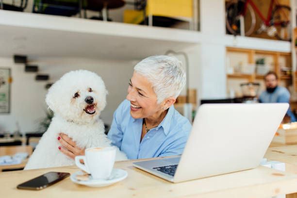 istock Mature Woman Sitting In Cafe With Her Dog 603835546