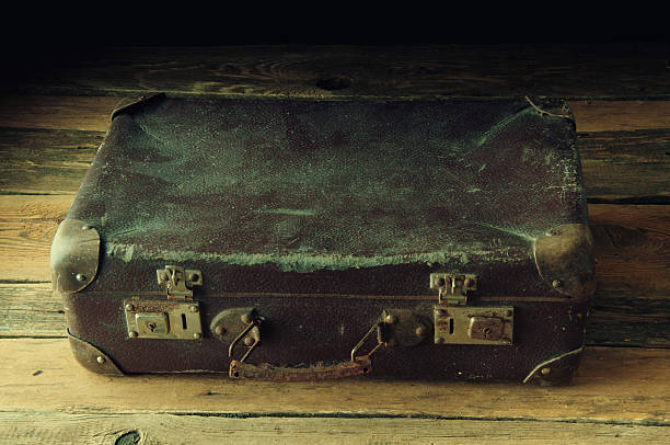 istock Vintage suitcase on wooden floor 603836108
