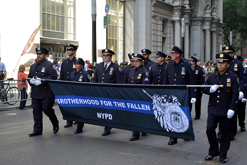 New York, New York - September 8, 2016: Members of the NYPD marching on Broadway in a procession honoring police officers killed in the 9/11 attacks at the World Trade Center in Lower Manhattan in New York City in 2016.