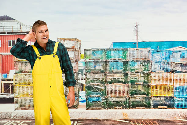 istock Smiling worker in front of fishing industry 603841842