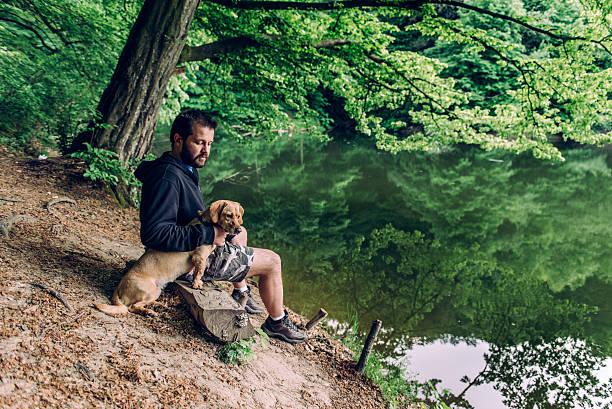 istock Man with the dog sitting on the bench 603845848