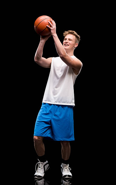 istock Smiling male athlete playing with basketball 603848352