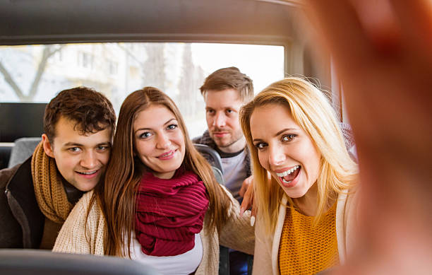 istock Group of young people traveling by bus, taking selfie 603848846