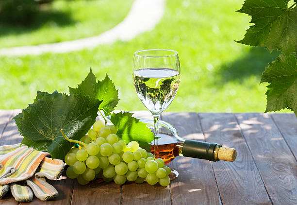 istock White wine bottle and glass with white grape 603848854