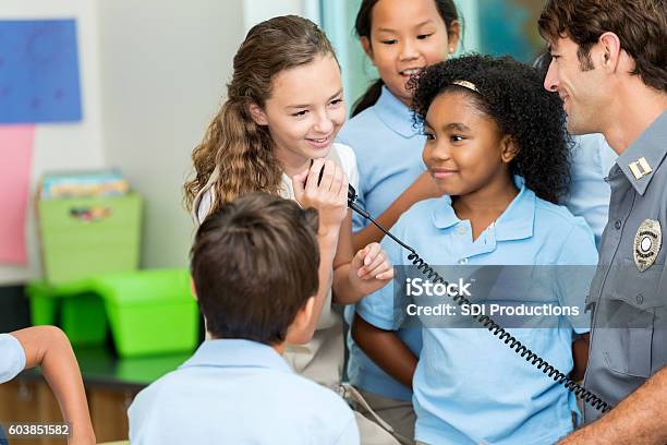 Schoolgirl Talks On Police Officers Walkie Talkie Stock Photo - Download Image Now - Police Force, Child, African Ethnicity