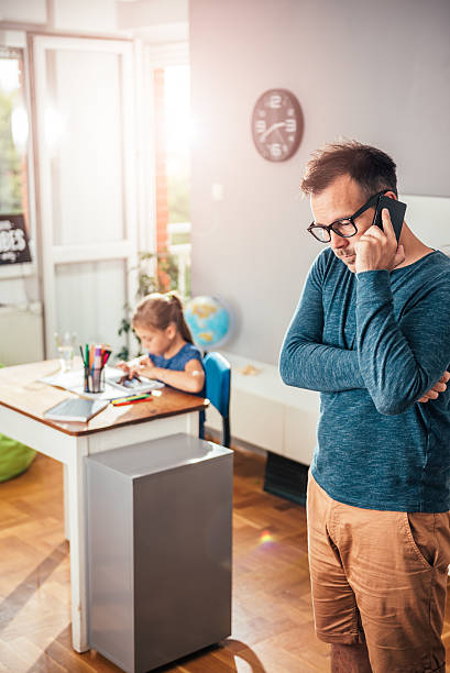 istock Father talking on phone in kids room 603851830