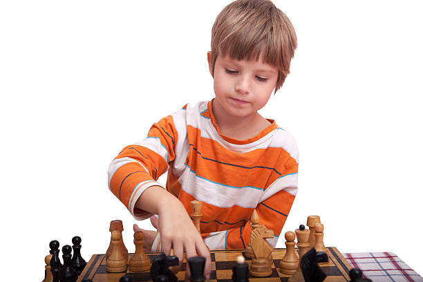 istock Cute little child playing chess 603852794