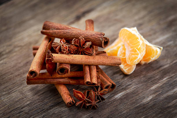 istock Cinnamon sticks and anice on wooden table. selected focus 603853230