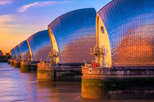 Thames Barrier, located downstream of central London at sunset