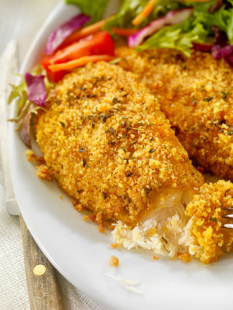 istock Breaded and Baked Fish Fillets with side Salad 603854296