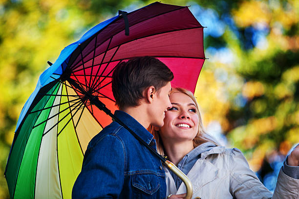 istock Loving couple on date under umbrella. 603854886