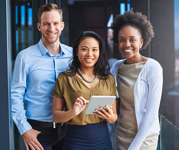 we're committed to a paperless office - three people imagens e fotografias de stock