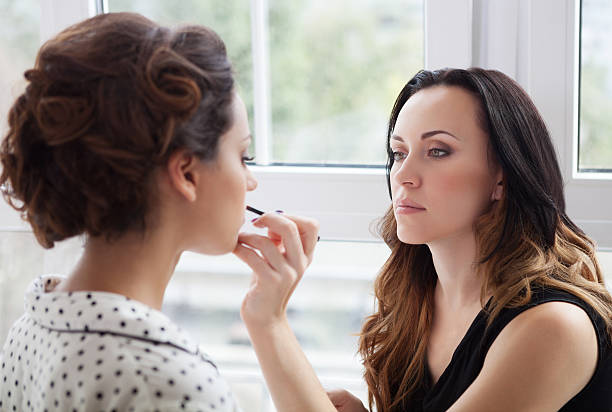istock Make-up artist doing make up for young beautiful bride 603857630