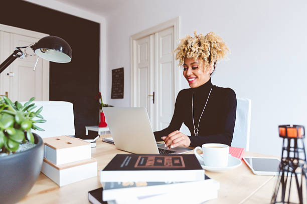istock Afro american young woman using laptop in an office 603857884