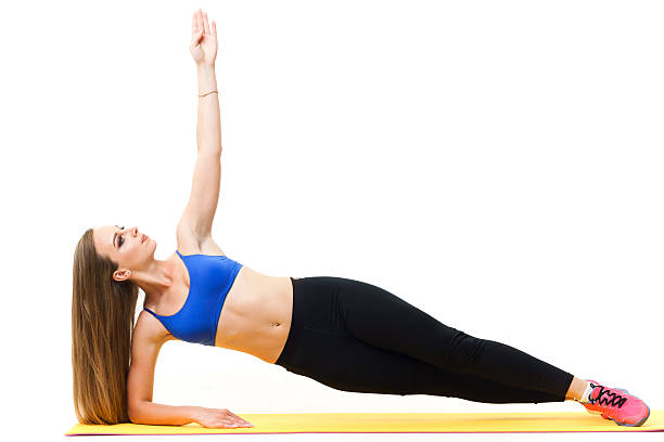 istock Beautiful trainer working out with yoga mat isolated on white 603857904