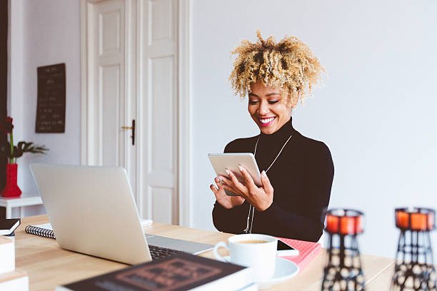 istock Afro american young woman using digital tablet in an office 603858522