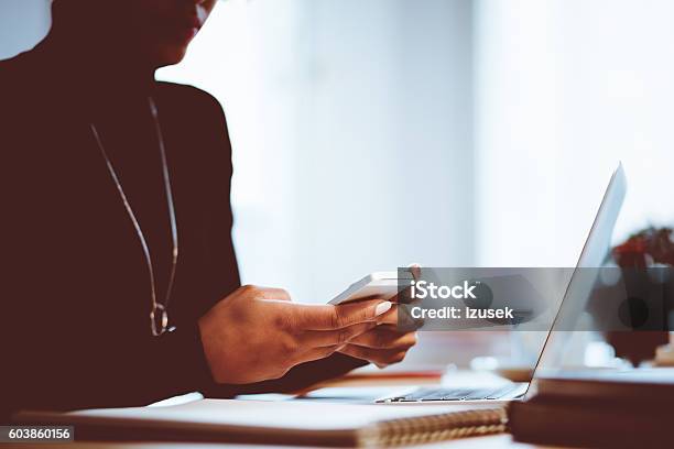 Elegance Woman Using Mobile In An Office Or At Home Stock Photo - Download Image Now