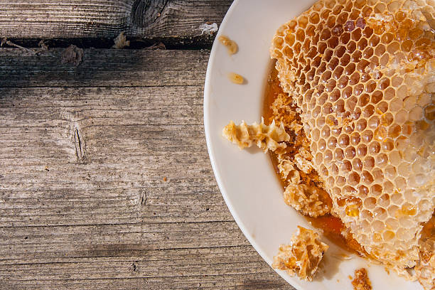 istock White plate with section of wax honeycomb from beehive 603860876