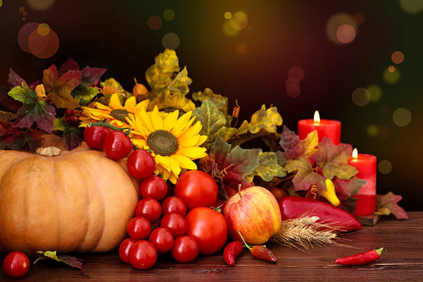 Autumnal fruits and vegetables against defocused holiday lights.