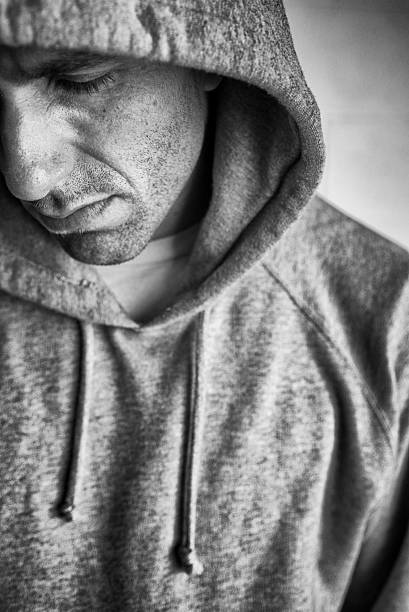 istock Depressed Man in Dirty Gray Hoody Looking Down 603861436