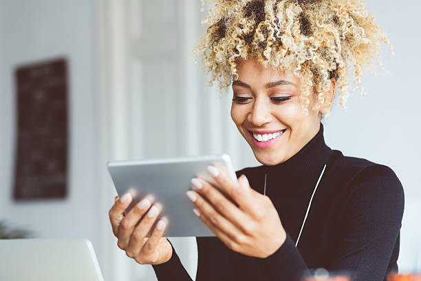 afro american young woman using digital tablet in an office - human face close up horizontal ideas imagens e fotografias de stock