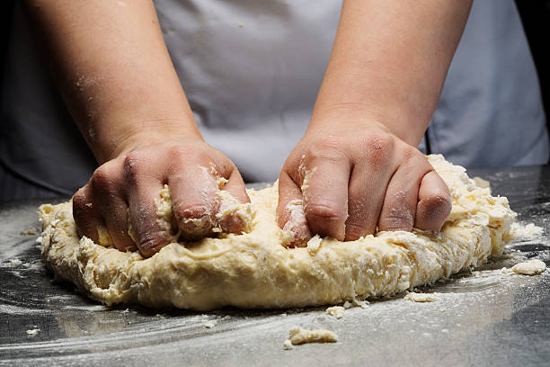 istock Woman hands kneading dough. 603862332