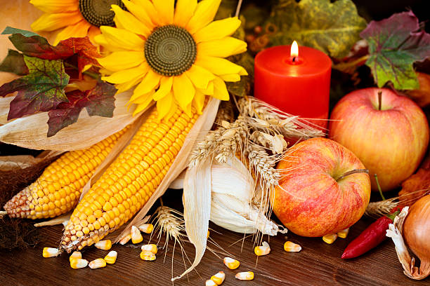 Autumnal arrangement with pumpkins, leaves and sunflowers.