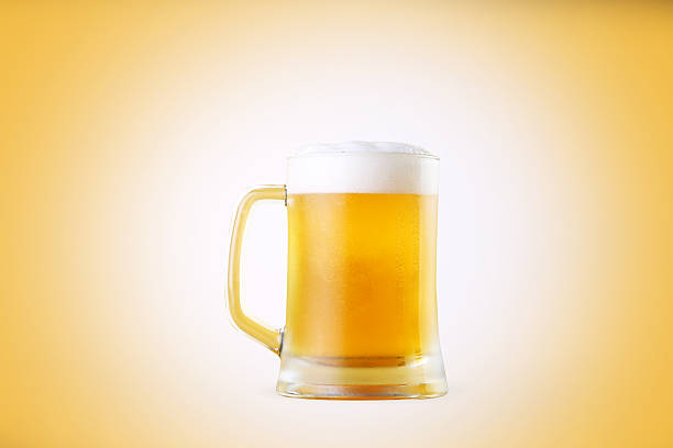 single object glass of beer yellow background