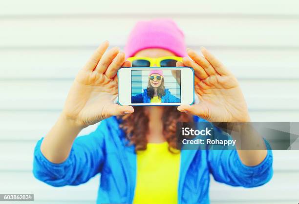 Fashion Pretty Cool Girl Taking Photo Self Portrait On Smartphone Stock Photo - Download Image Now