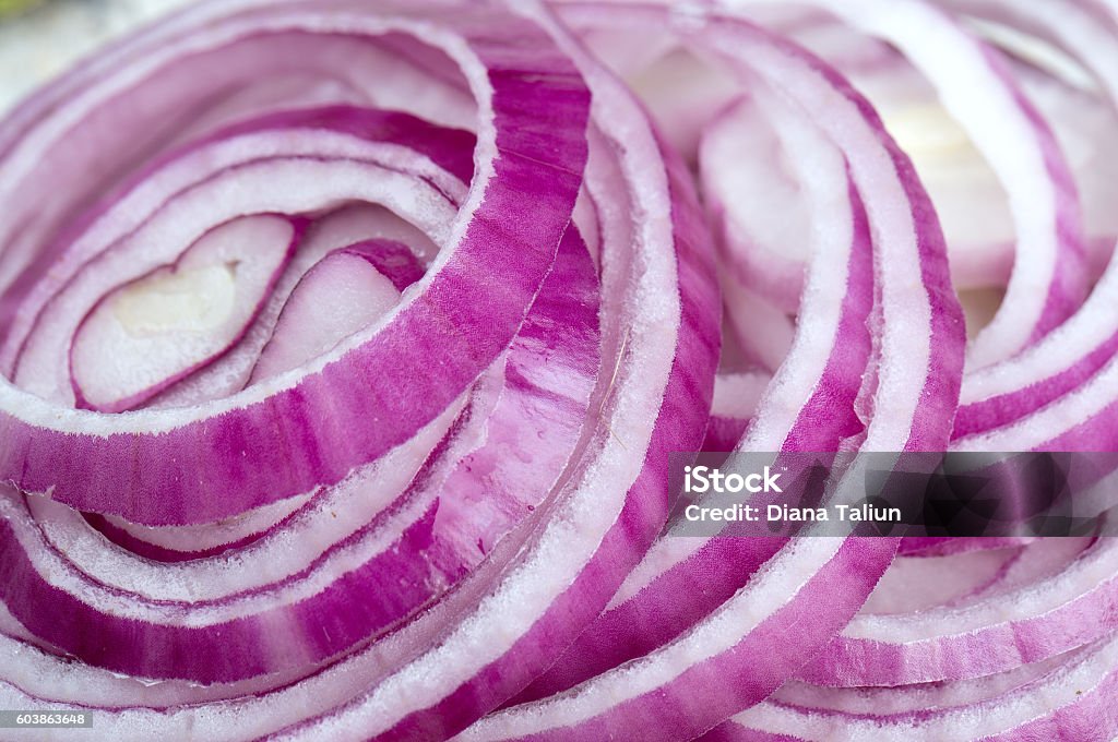 red onion on wooden surface Onion Stock Photo
