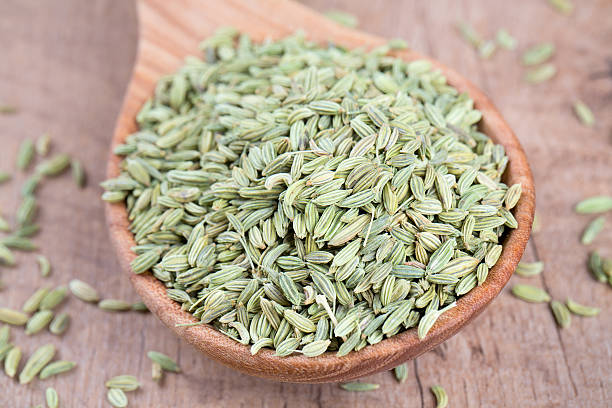 istock fennel seed in a wooden spoon on table 603864388