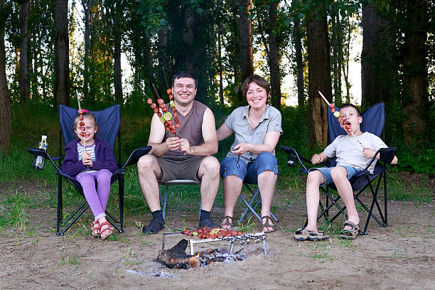 istock family in forest on picnic, make barbecue, meat cooked 603864558