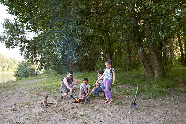 istock people camping in forest, family active in nature, kindle fire 603864800