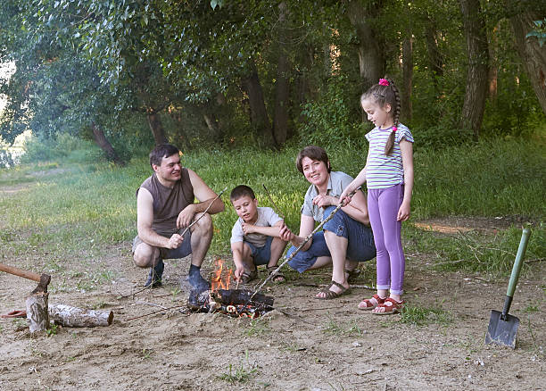 istock people camping in forest, family active in nature, kindle fire 603864946