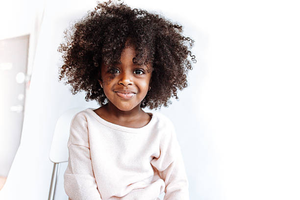 Adorable girl looking at camera Adorable girl looking at camera afro stock pictures, royalty-free photos & images